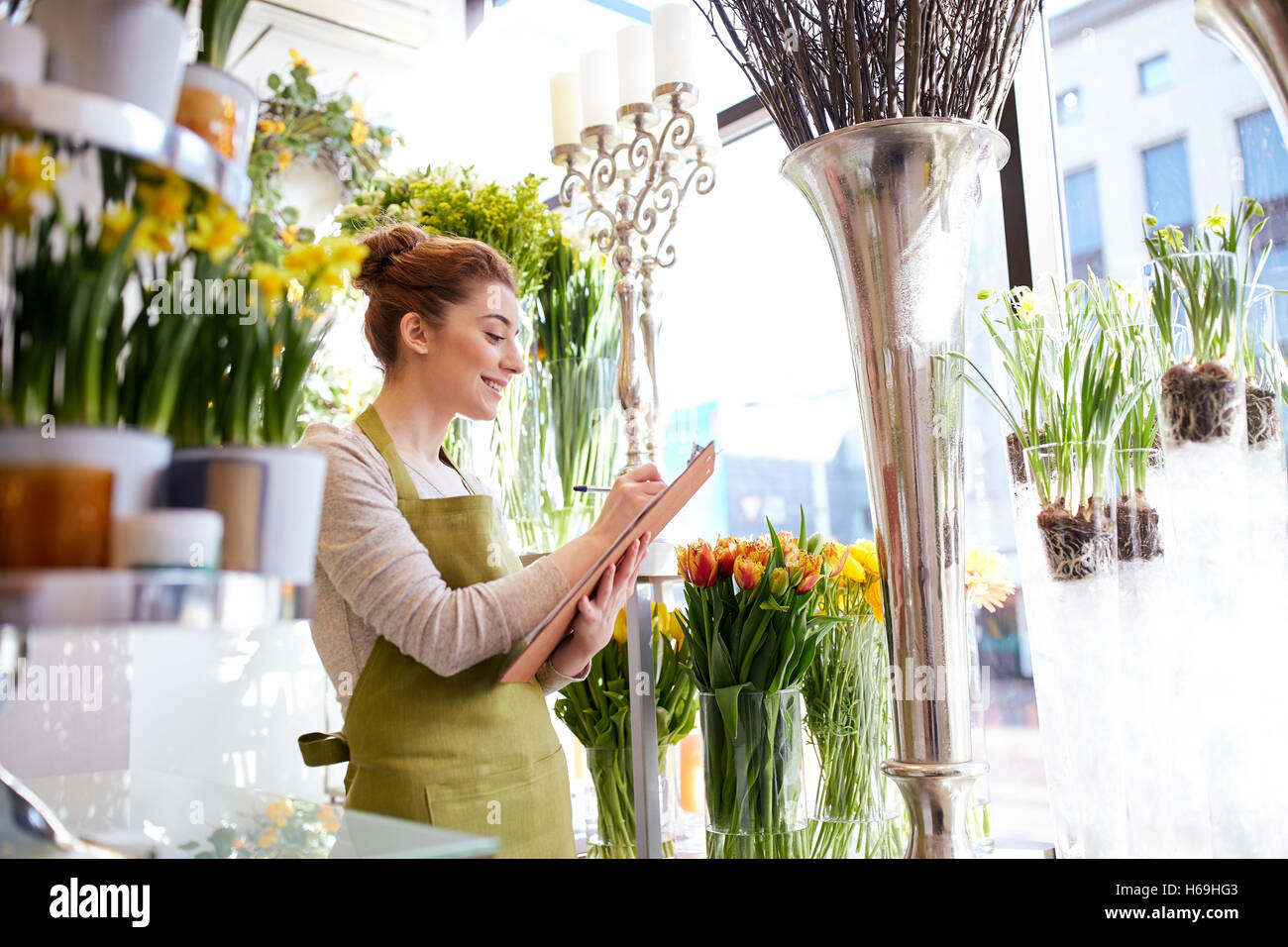 florist woman with clipboard at flower shop Stock Photo - Alamy