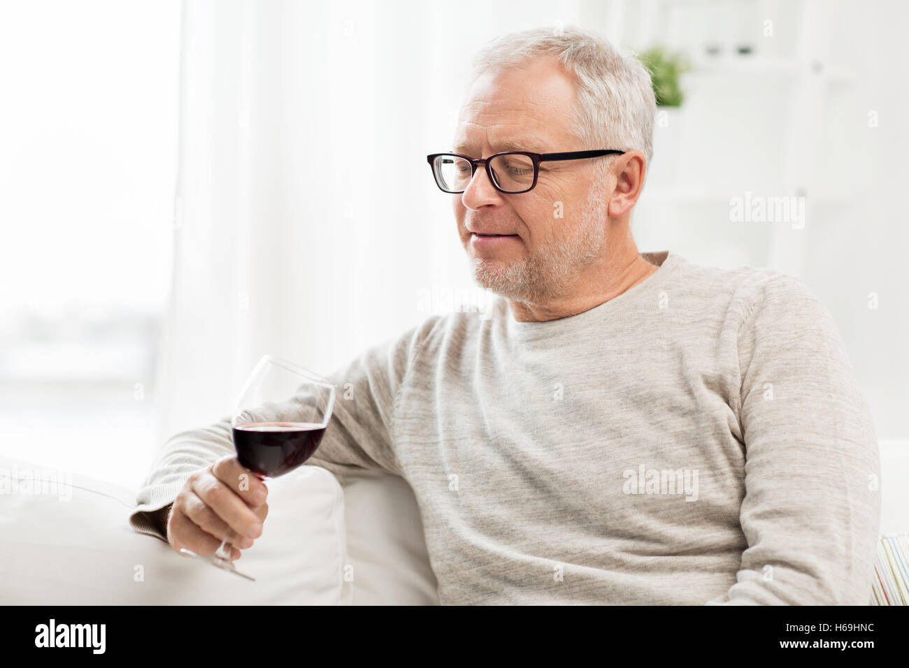 senior man drinking red wine from glass at home Stock Photo - Alamy