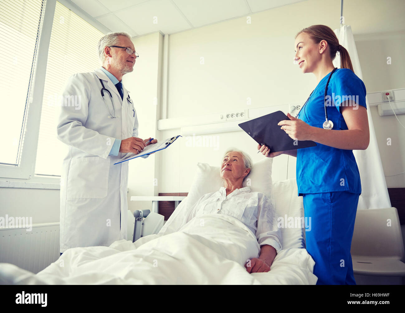 doctor and nurse visiting senior woman at hospital Stock Photo - Alamy