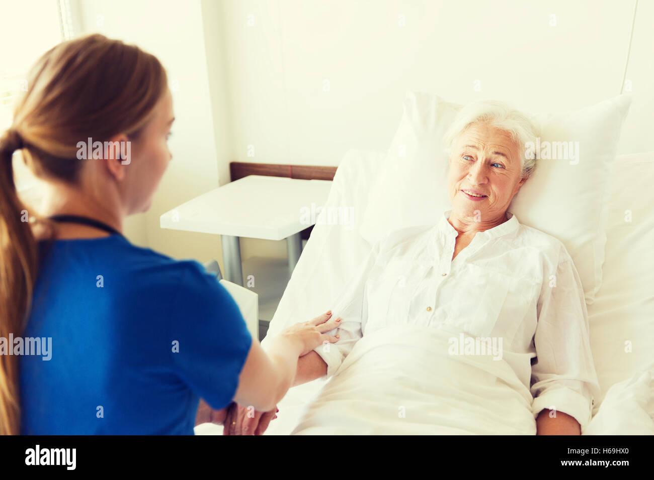 doctor or nurse visiting senior woman at hospital Stock Photo - Alamy
