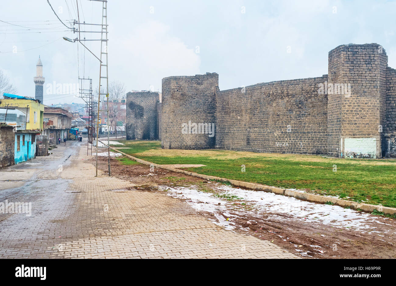 The  black citadel wall surrounds the old town with the small colorful houses and numerous mosques Stock Photo