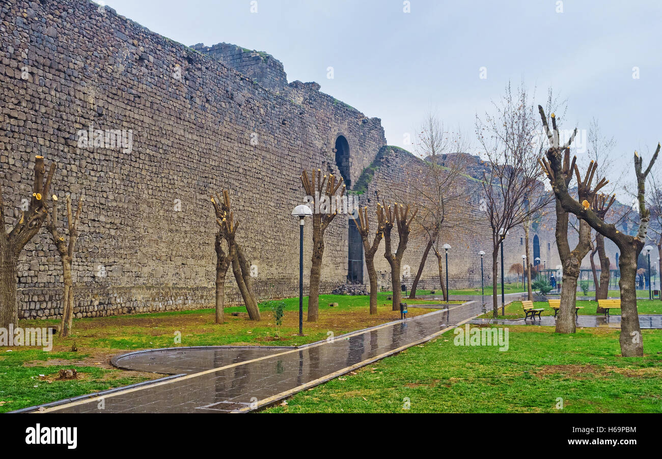 The citadel walls of Diyarbakir neighboring with the city garden, Turkey. Stock Photo