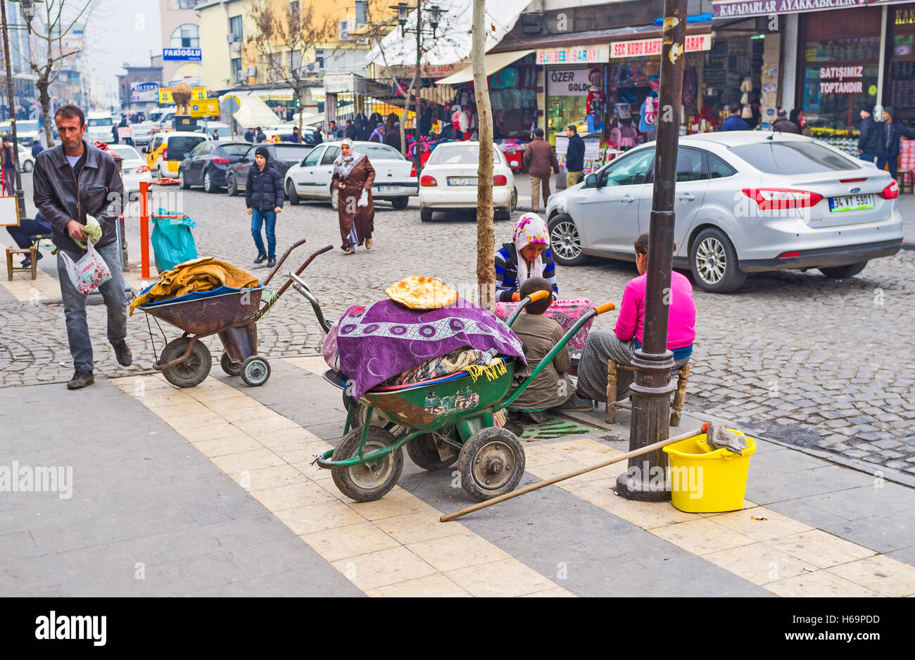 The  young girls sell the flatbread from the carts on the market street Stock Photo