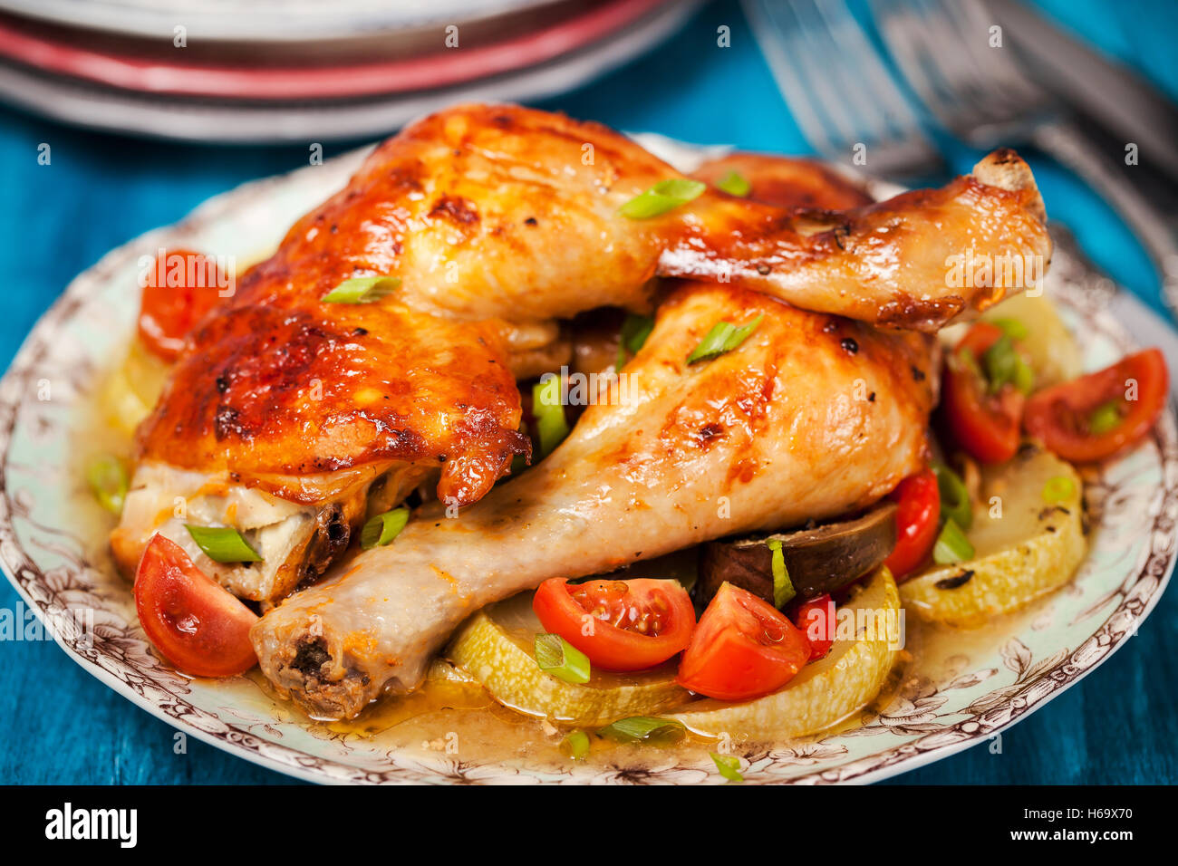 Oven roasted chicken legs with vegetables, ready to eat Stock Photo