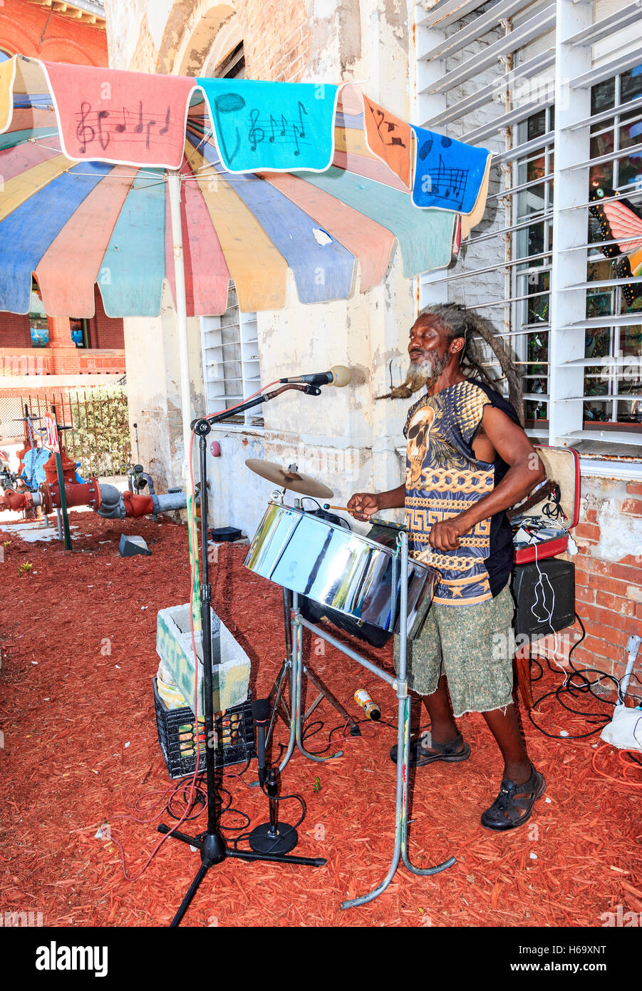 Man plays kettle drums along Front Street in Key West, Florida near waterfront. Stock Photo