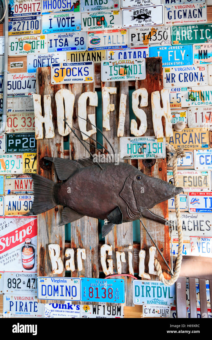 Car license tags nailed to wall at Quirky sign at Hogfish Bar & Grill. A great, local, authentic place for fish in Florida Keys Stock Photo