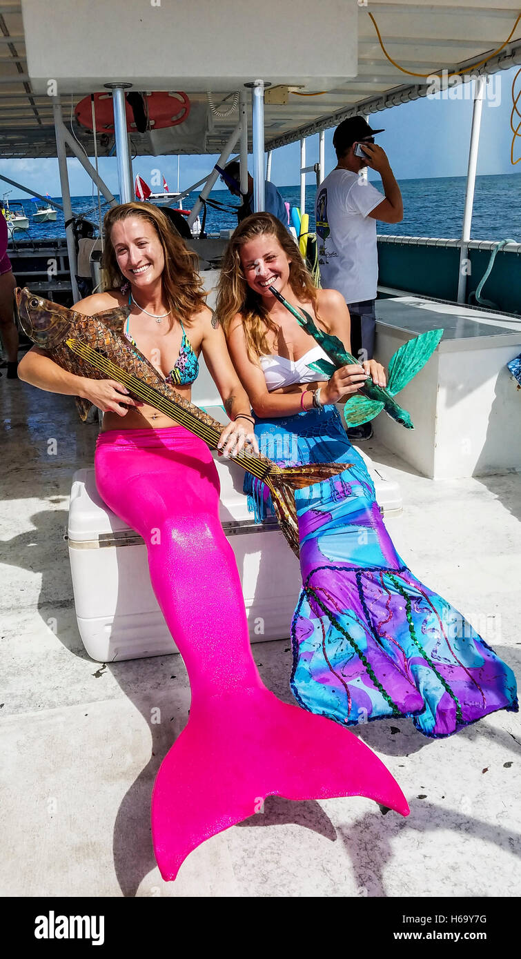 Two 'mermaids' practice performing for the Lower Keys Underwater Music Festival along a reef off Looe Key, Stock Photo