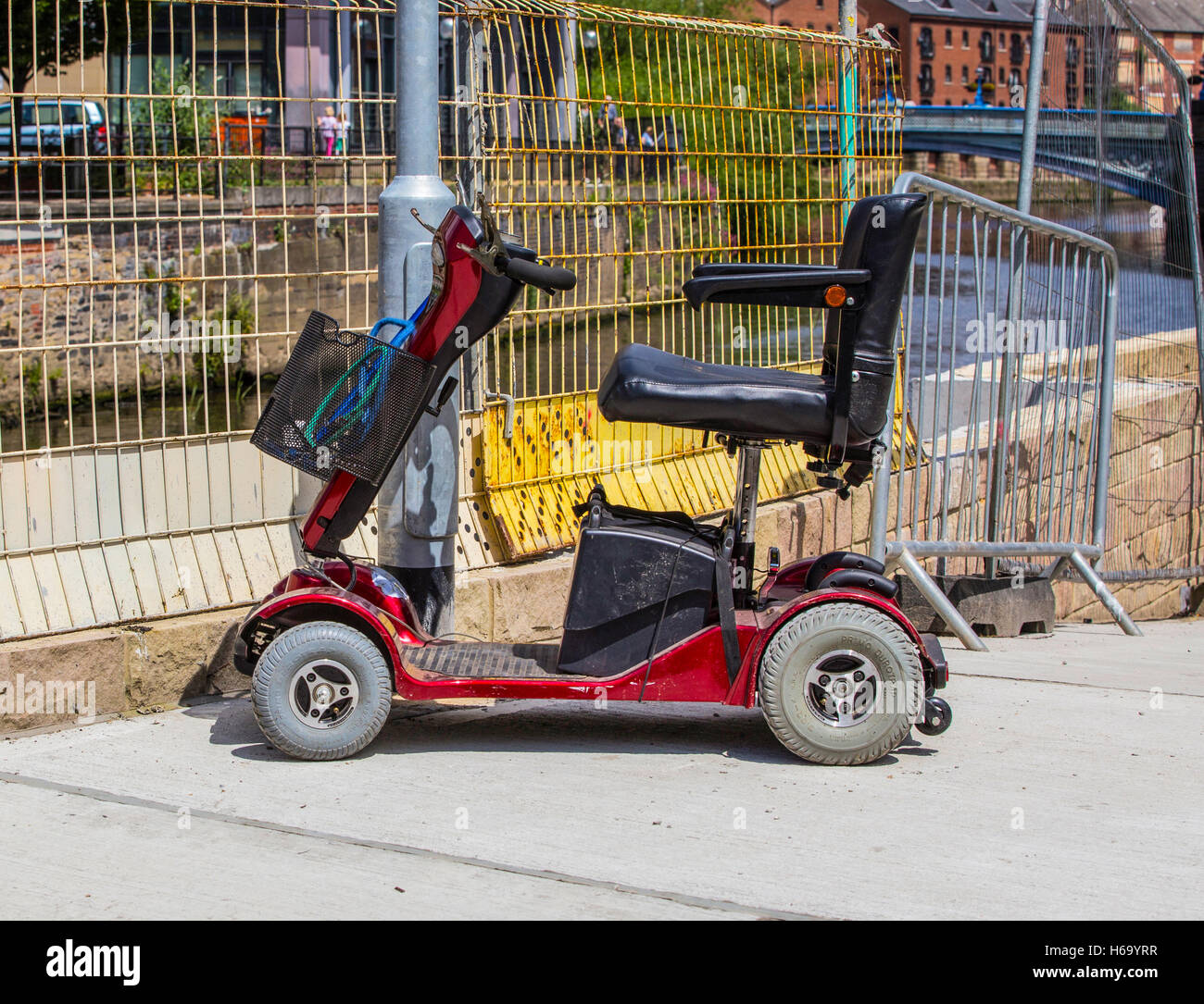 Mobility Scooter parked on pavement Stock Photo Alamy