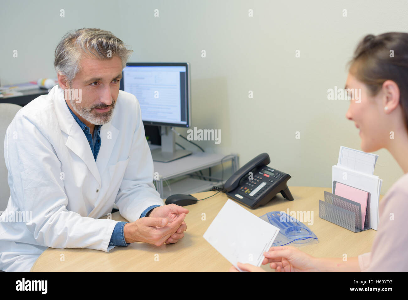 Male doctor talking to female patient Stock Photo