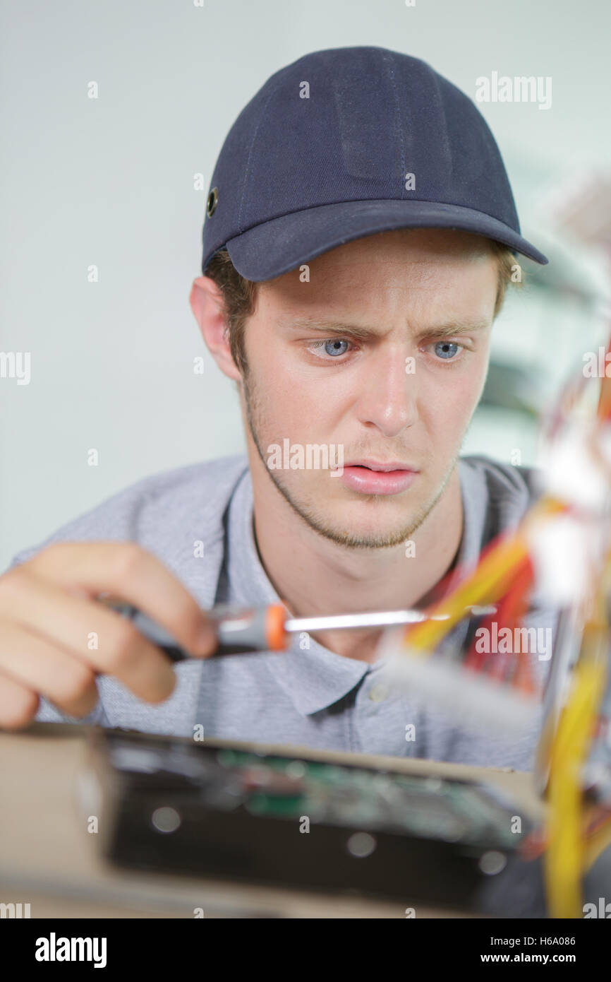 Young electrician with puzzled expression Stock Photo