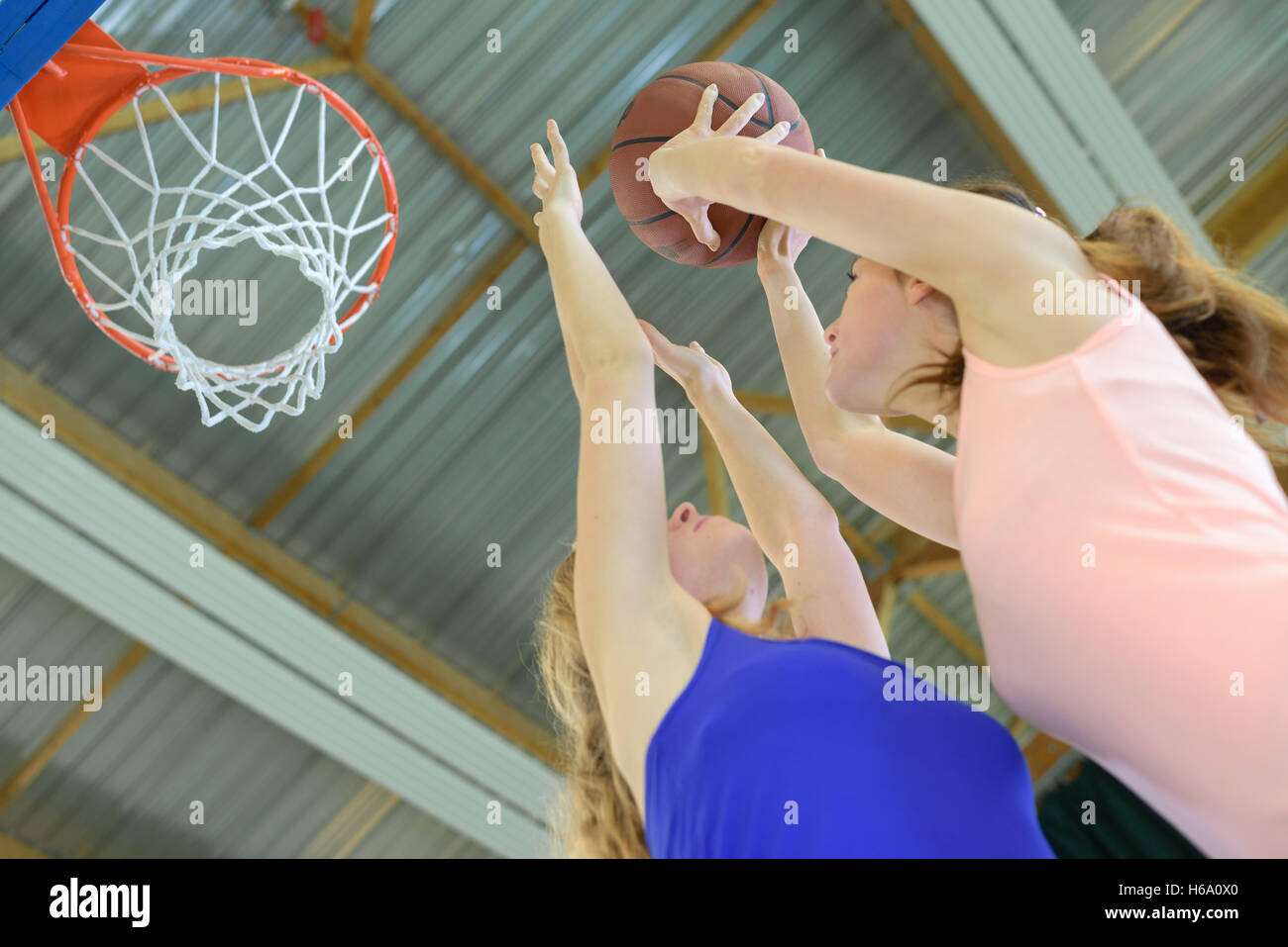 Woman aiming towards basketball net Stock Photo