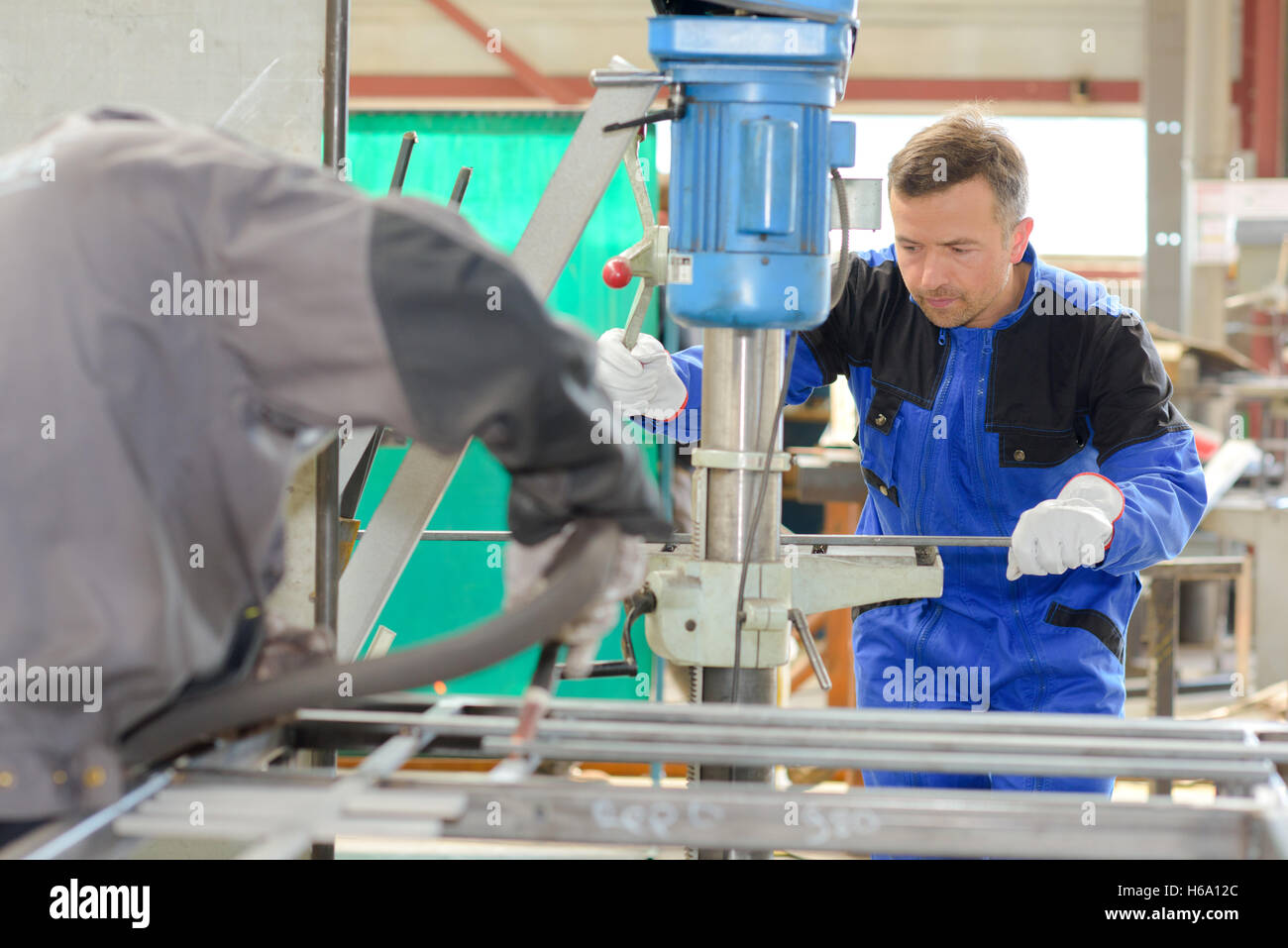 Workman using hydraulic machine Stock Photo - Alamy