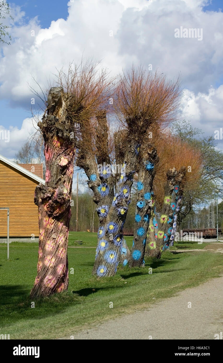 tree trunks painted for art project, Iisalmi Finland Stock Photo