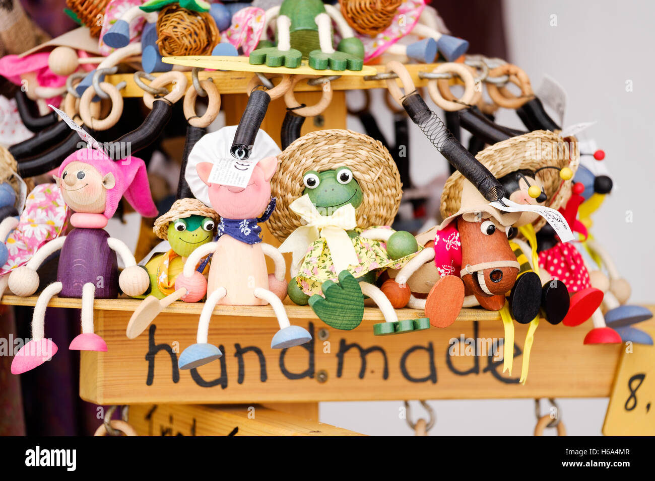 A display of handcrafted wooden toy animals and characters for sale outside a shop Stock Photo