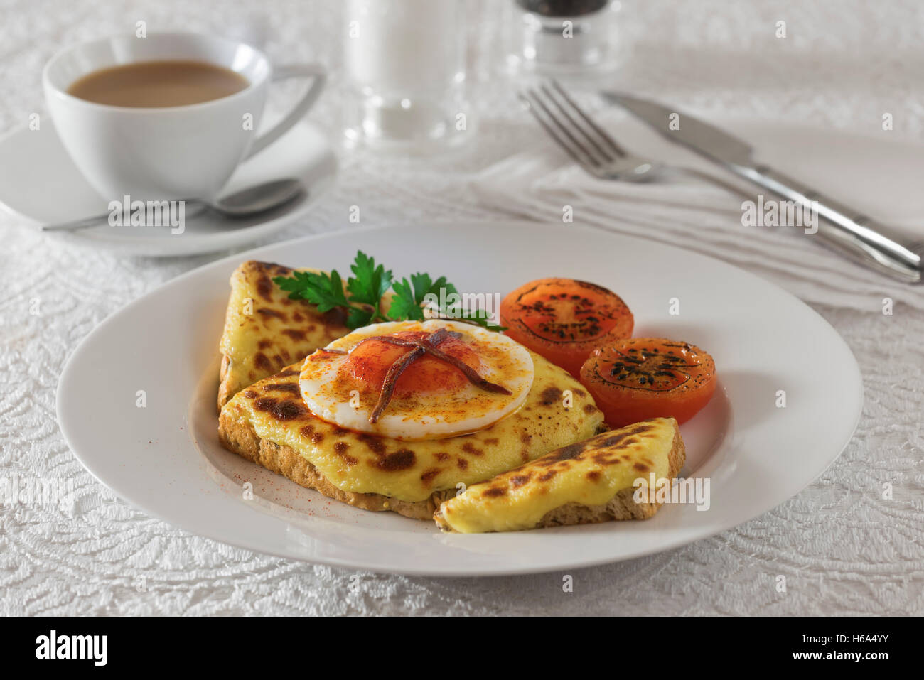 Buck rarebit. Grilled cheese topping on toast with a poached egg. Stock Photo