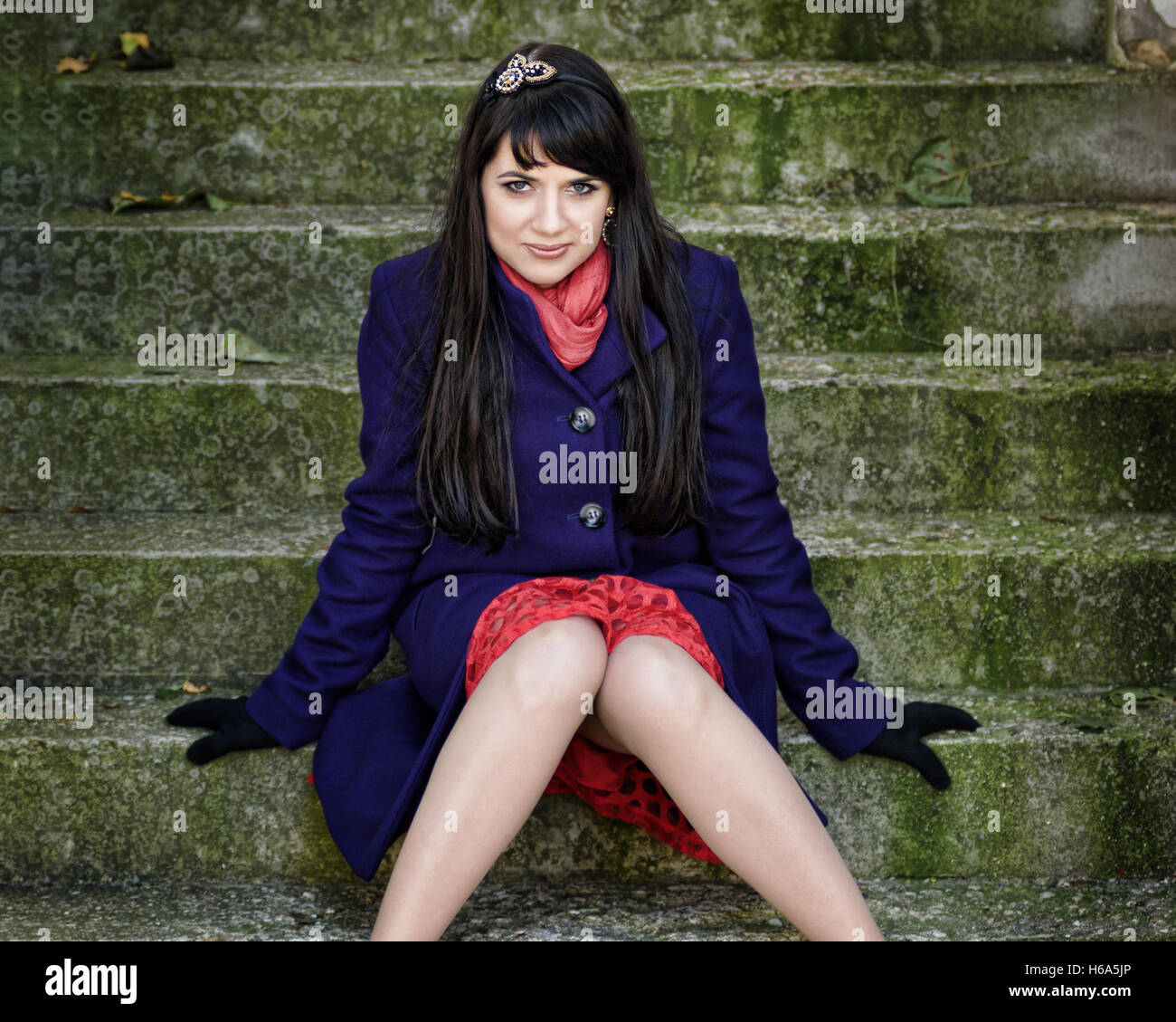 Pretty woman on dirty stairs Stock Photo