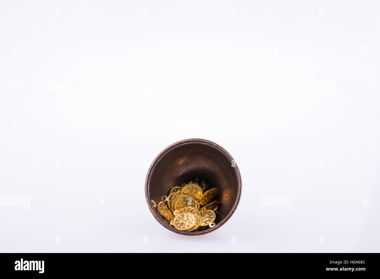 Fake gold coins in an old decorative metal  plate Stock Photo