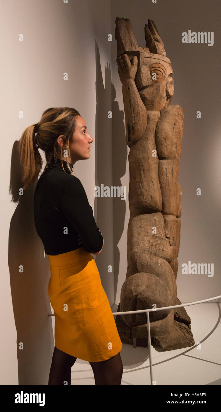 London, UK. 26 October 2016. A museum employee looks a the wood sculpture Christ with Football, 1992, by Jackson Mbhazima Hlungwani. The exhibition South Africa: The Art of a Nation opens at the British Museum and runs from 27 October 2016 to 26 February 2017. This is the first major UK exhibition on South African art to explore 100,000 years of history through archaeological, historic and contemporary artworks. Stock Photo