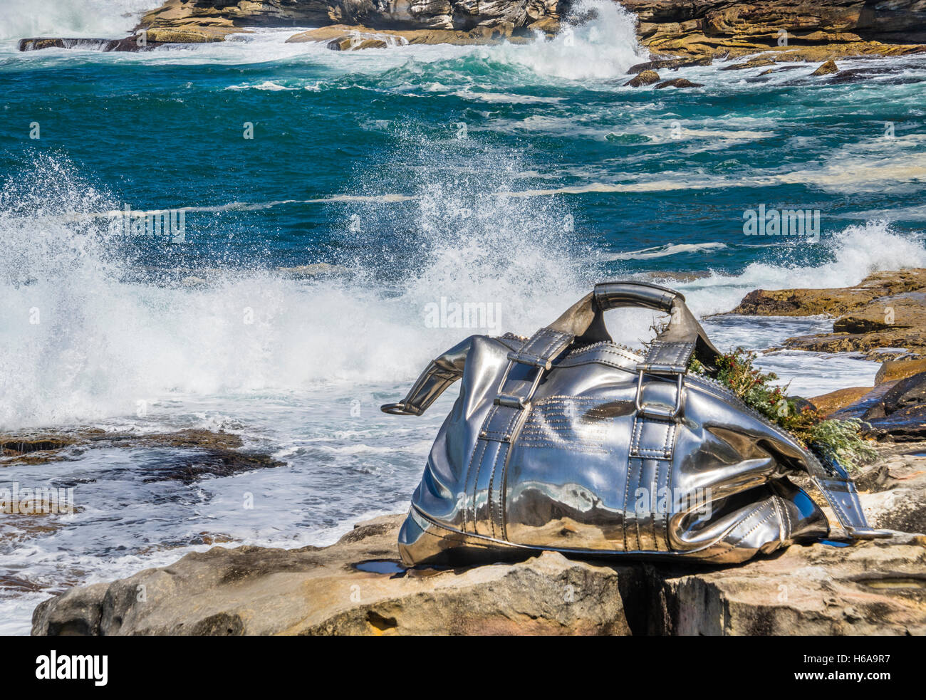 Bondi Beach, Sydney, Australia. 24th Oct, 2016. Sculpture by the Sea, Australia's largest annual outdoor sculpture exhibition along the coastal walk from Bondi Beach to Tamarama Beach. Stainless steel sculpture by chinese sculptor Yumin Jing titled 'Travelling Bag' Credit:  Manfred Gottschalk/Alamy Live News Stock Photo