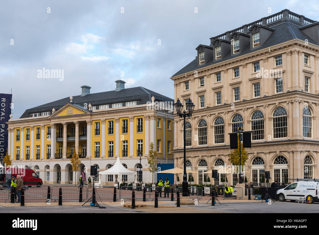 Poundbury, Dorset, UK. 26th Oct, 2016. UK Weather. Queen Mother square in Poundbury in Dorset being readied for the visit of The Queen tomorrow (Thursday 27th) for the unveiling of the statue of the Queen Mother. Also in attendance for the unveiling will be The Duke of Edinburgh, Prince Charles and Camilla. Pictured are the Buckingham Palace replica called Strathmore House and The Duchess of Cornwall Inn. Picture Credit:  Graham Hunt/Alamy Live News Stock Photo