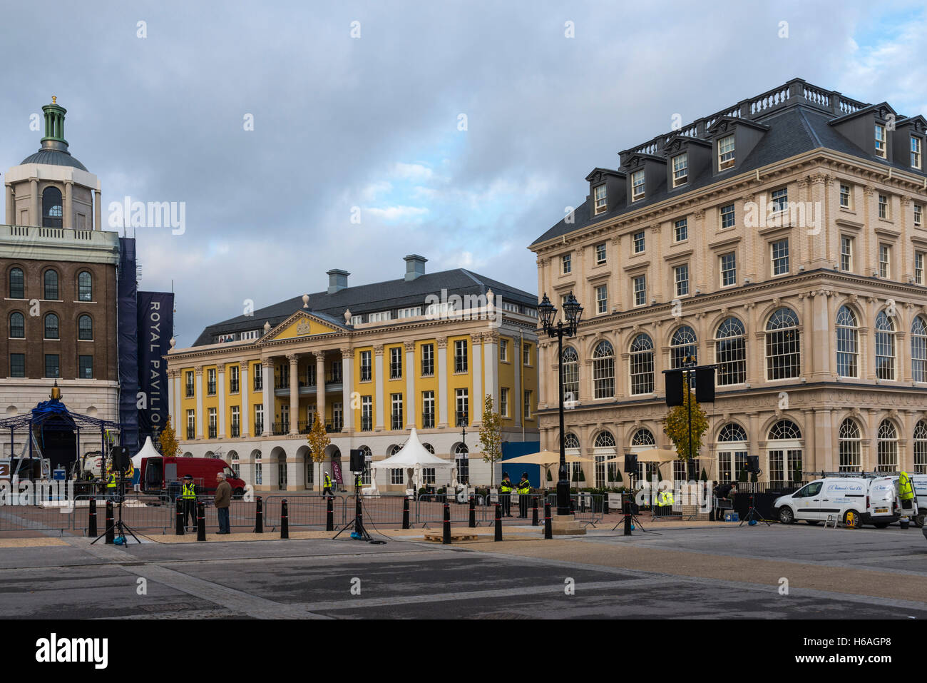 Poundbury, Dorset, UK. 26th Oct, 2016. UK Weather. Queen Mother square in Poundbury in Dorset being readied for the visit of The Queen tomorrow (Thursday 27th) for the unveiling of the statue of the Queen Mother. Also in attendance for the unveiling will be The Duke of Edinburgh, Prince Charles and Camilla. Pictured are the Buckingham Palace replica called Strathmore House and The Duchess of Cornwall Inn. Picture Credit:  Graham Hunt/Alamy Live News Stock Photo