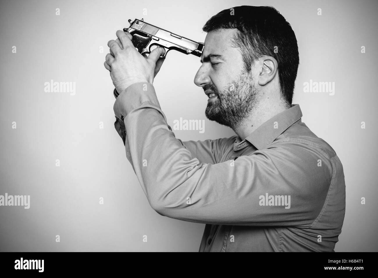 Old man pointing gun stock photo - apimens