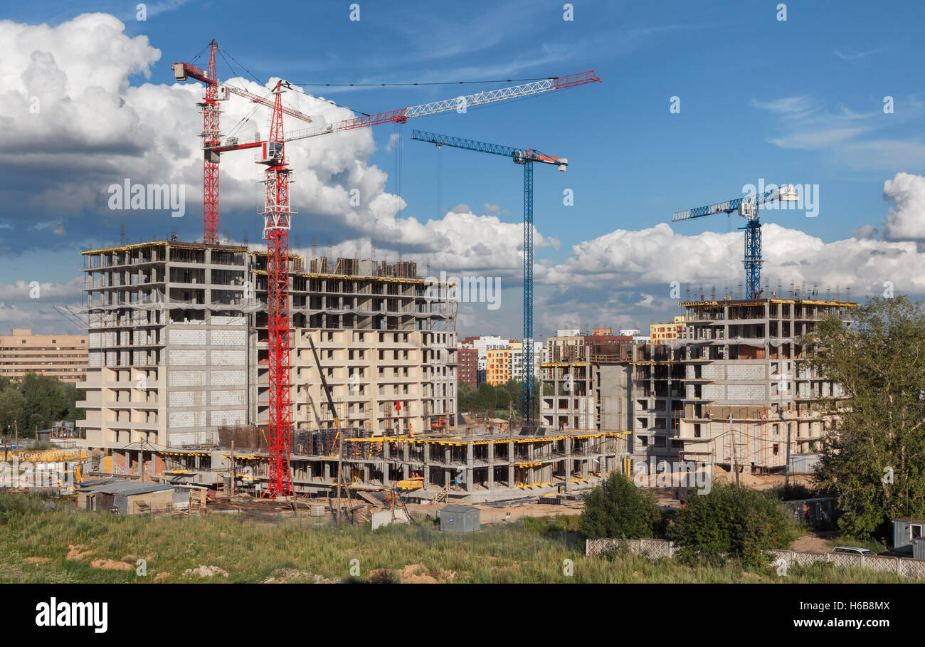 Lots of tower cranes build residential buildings at day Stock Photo - Alamy
