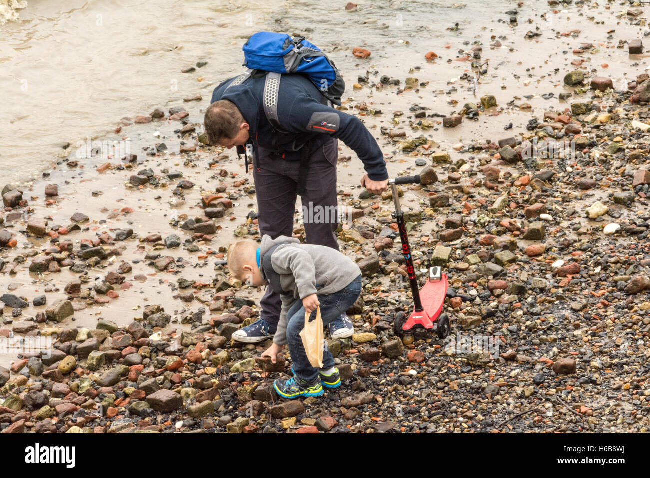 A father and son mud larking on the River Thames in central London, England, U.K. Stock Photo