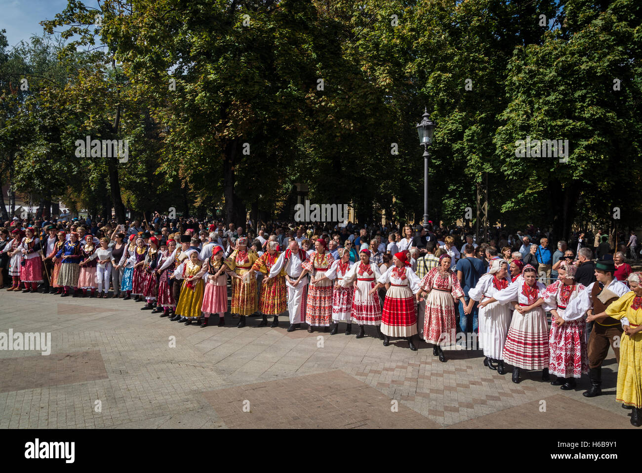 People joining in a huge circle dance at Vinkovačke jeseni, a traditional folklore Festival, Vinkovci, Croatia Stock Photo