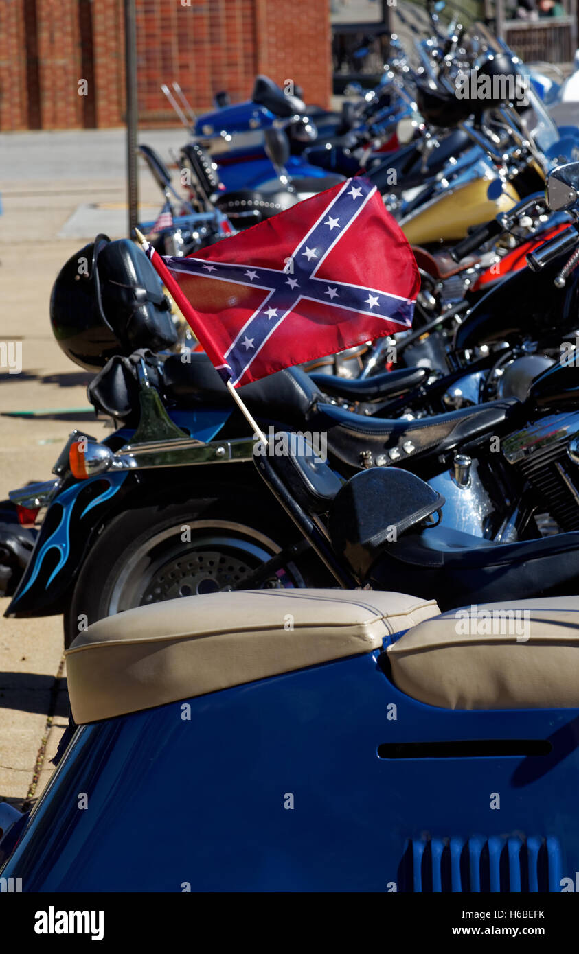Row of motorcycles with one flying a confederate flag Stock Photo