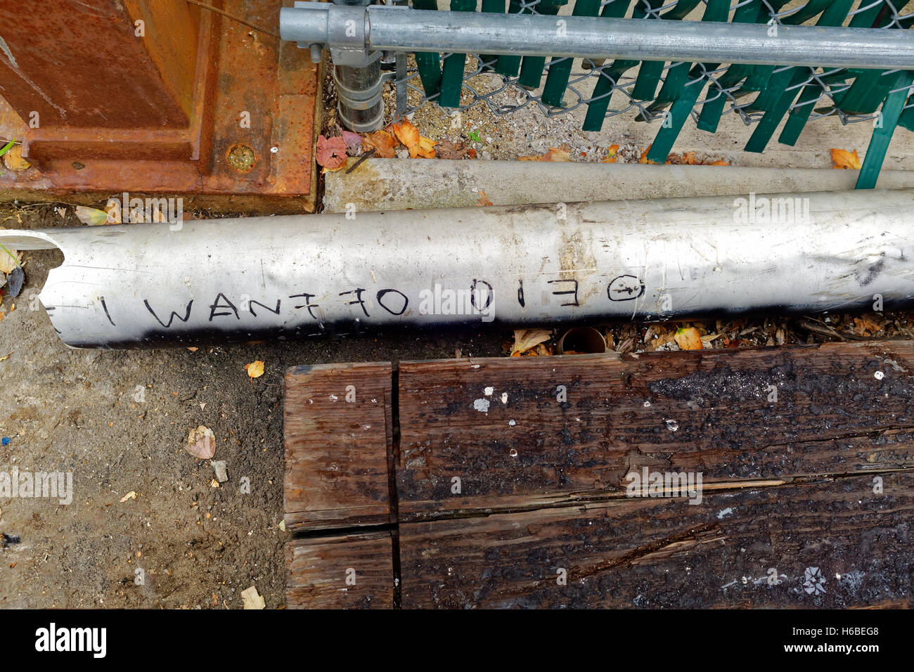 Meaning of Depression-'I WANT TO DIE' scrawled on a discarded broken piece of pipe. Stock Photo