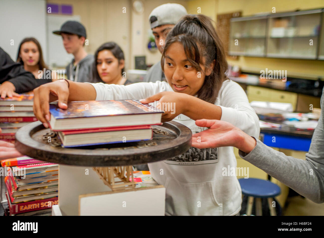 https://c8.alamy.com/comp/H6BF24/a-hispanic-high-school-student-in-mission-viejo-ca-stacks-weights-H6BF24.jpg
