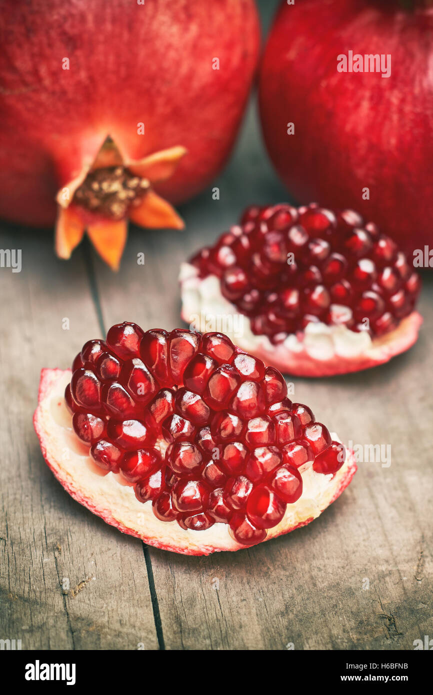 Ripe pomegranate fruit on grey wooden rustic background Stock Photo