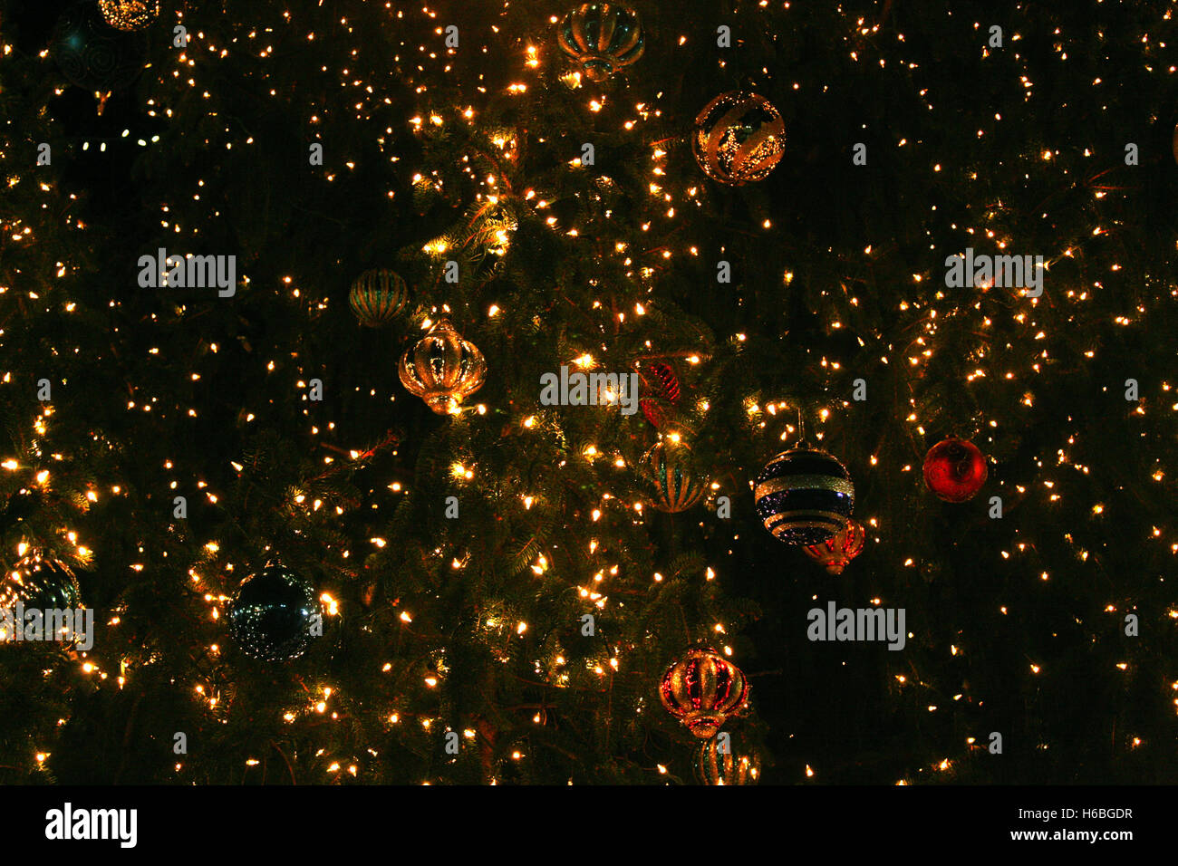 Globes and lights in large Christmas tree Stock Photo Alamy