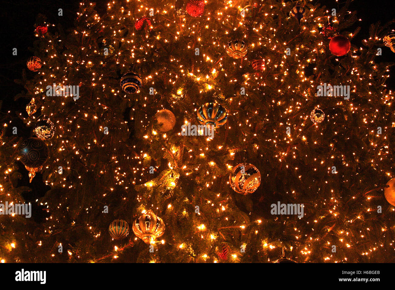 Globes and lights in large Christmas tree Stock Photo Alamy