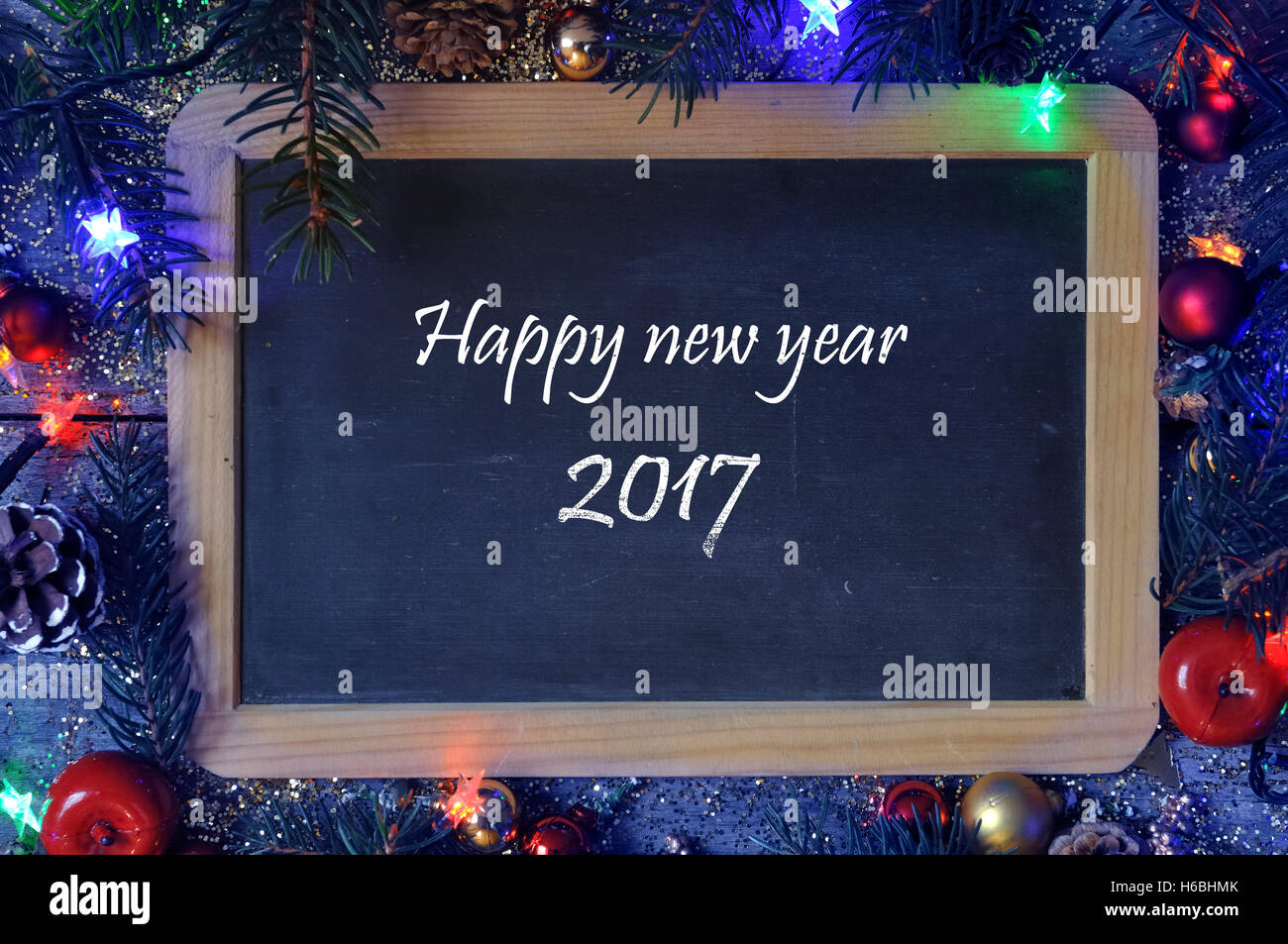 Happy new year 2017 written on a slate on Christmas decoration Stock Photo