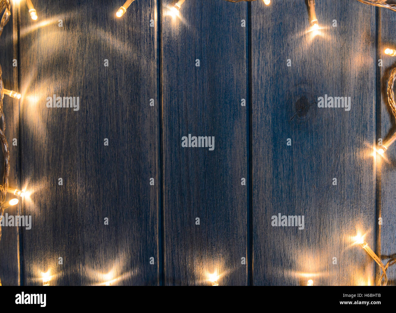 Christmas lights on wooden table Stock Photo - Alamy