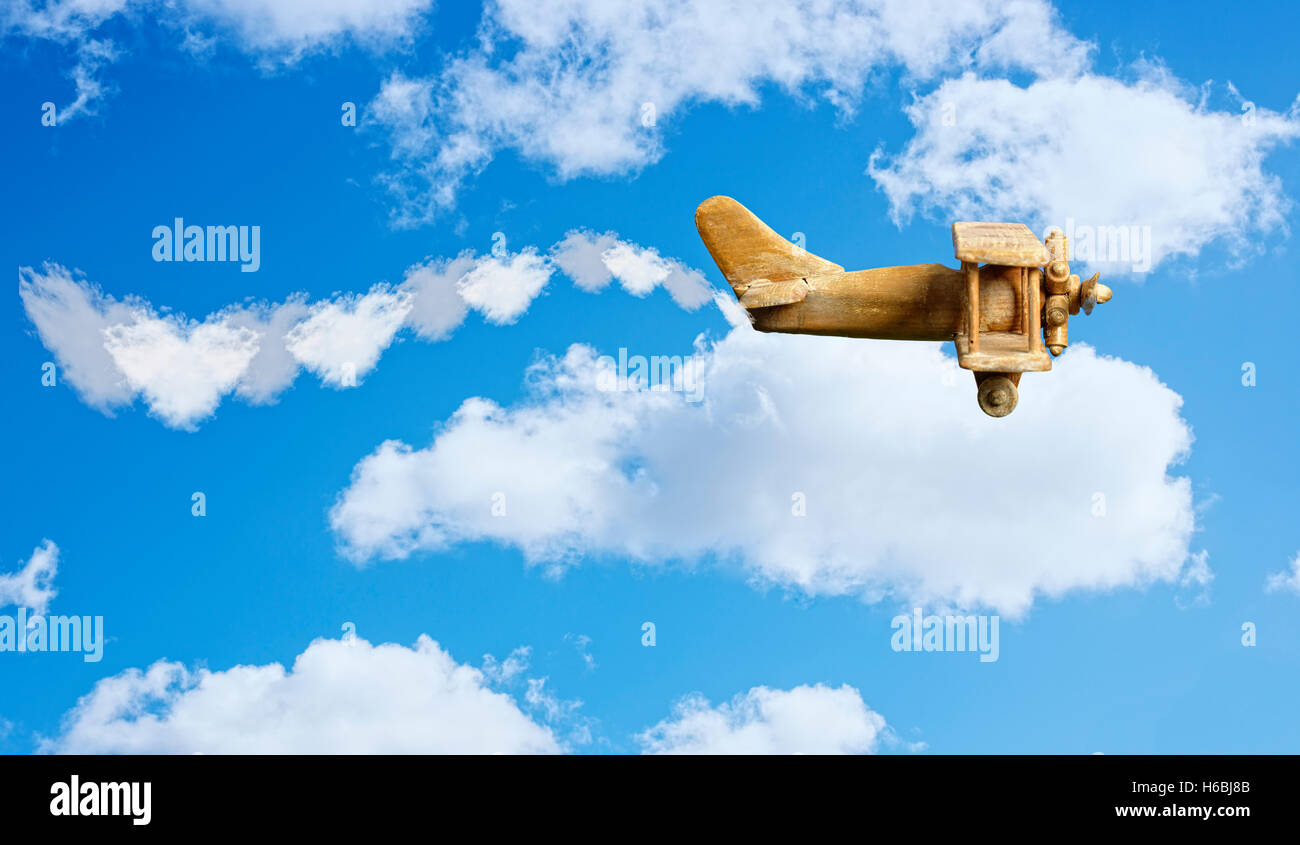 Toy plane in bright blue sky Stock Photo