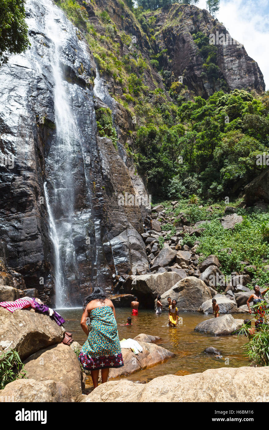 Local Sri Lankan family bathes in a waterfall Stock Photo