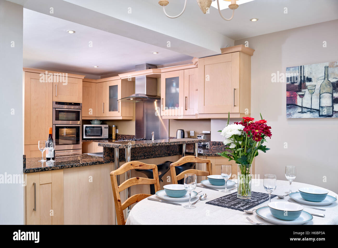 A contemporary, typical kitchen dinner, incorporating a range cooker, hood & Granite work surfaces. Gloucestershire, UK Stock Photo
