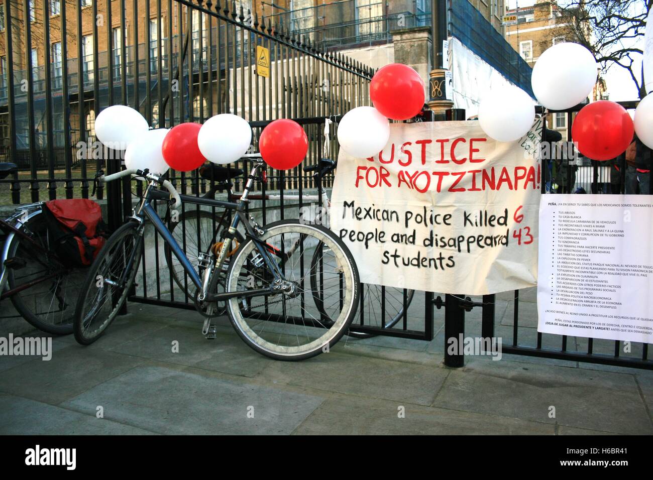 A pen reserved for protesters outside of Downing Street on Whitehall was covered in solidarity signs by protesters, who are drawing attention to the human rights abuses of the Mexican police, accused of killing 6 protesters and abducting 43 in the town of Ayotzinapa. Protesters have come to Downing Street as President Peña Nieto of Mexico makes a state visit to the UK. Stock Photo