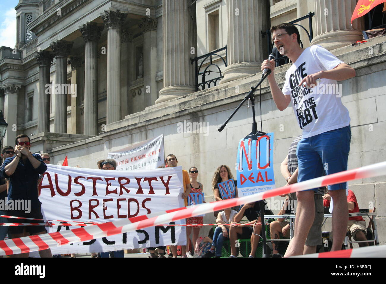 A member of the Jubilee Debt Campaign explains the idea of Jubilee “Its not about the Queen, it was a time when debts were cleared, slaves were freed and land was redistributed”. Greece’s debts are so large that they must be dropped he argues, to hundreds of protesters who have gathered on Trafalgar Square in solidarity with the Greek people - experiencing public spending cuts as a condition of the bailout of the economy. Stock Photo