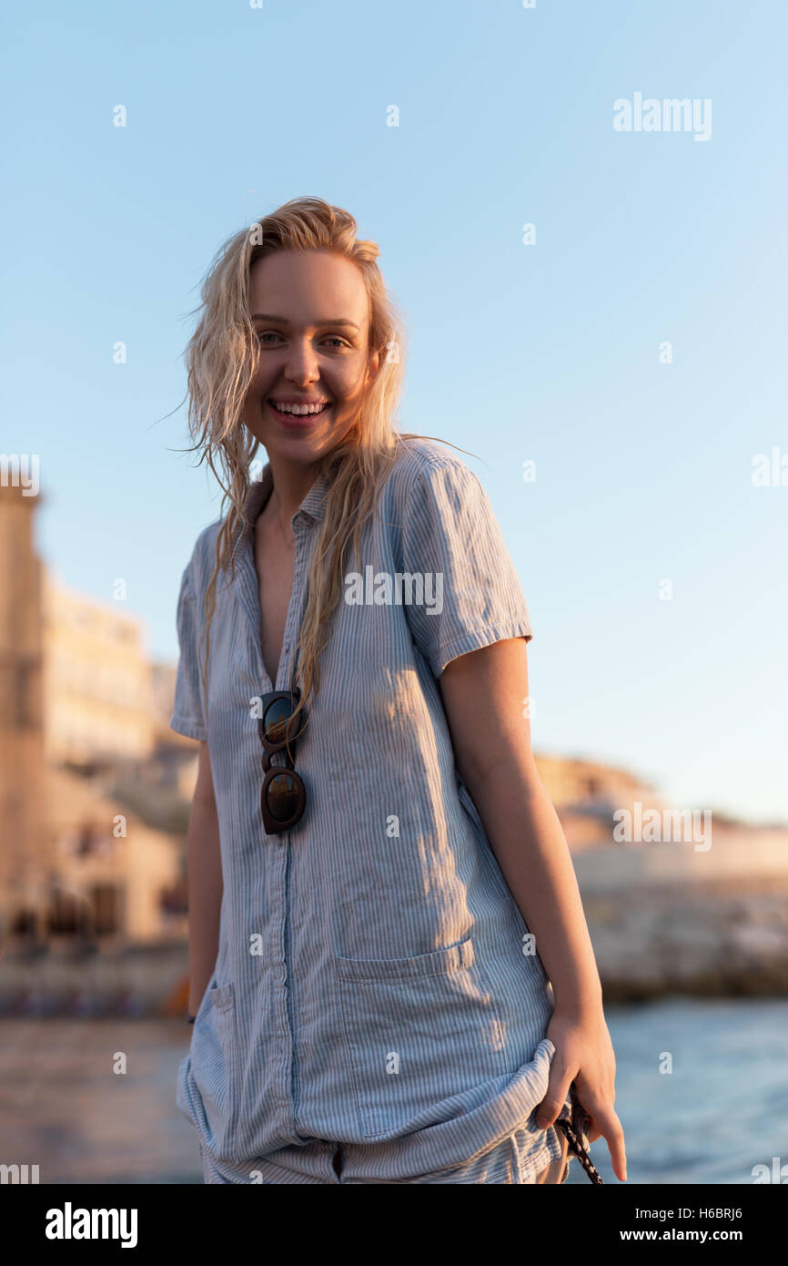 Happy carefree woman dancing at sunset on the beach. Happy free ...