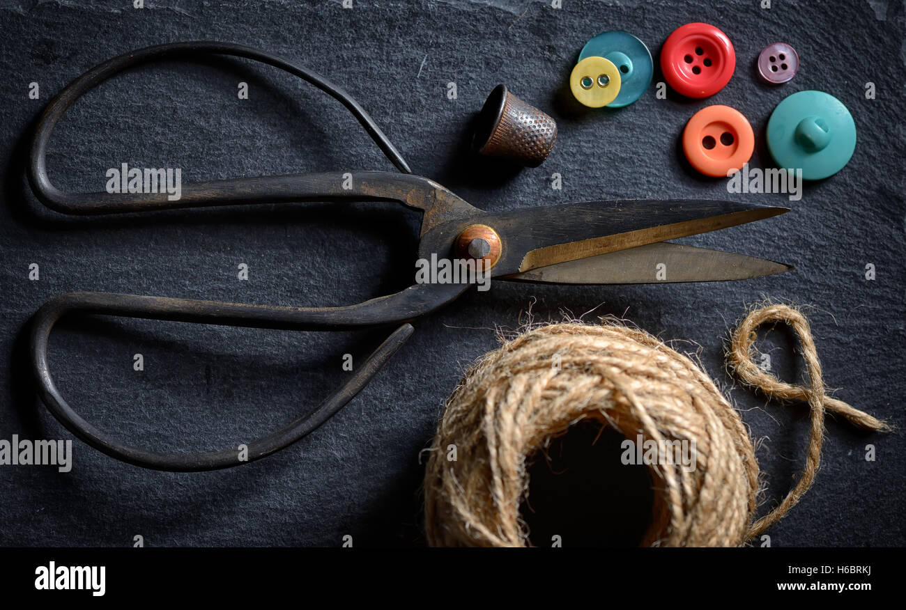 vintage scissors with a roll of twine and buttons Stock Photo