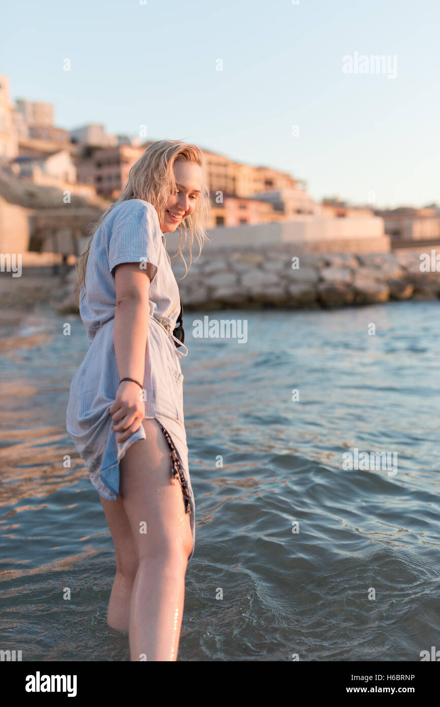 Happy carefree woman dancing at sunset on the beach. Happy free ...