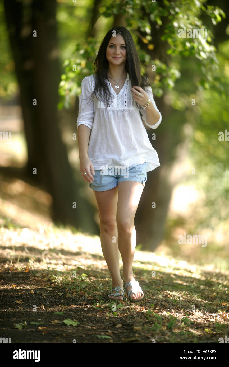 Young pretty smiling woman walks hi-res stock photography and images ...