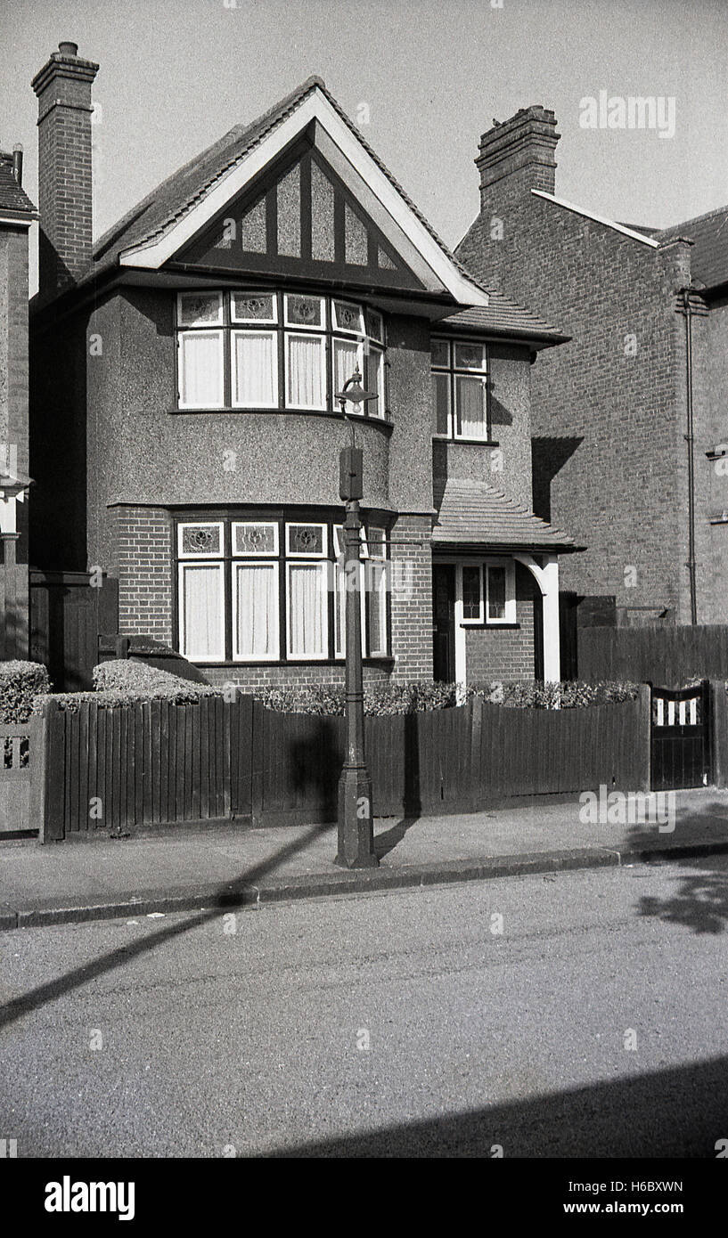 1930s, historical, exterior view of a typical interwar built pebble dash detached house with features such as porch and stained glass windows. Stock Photo