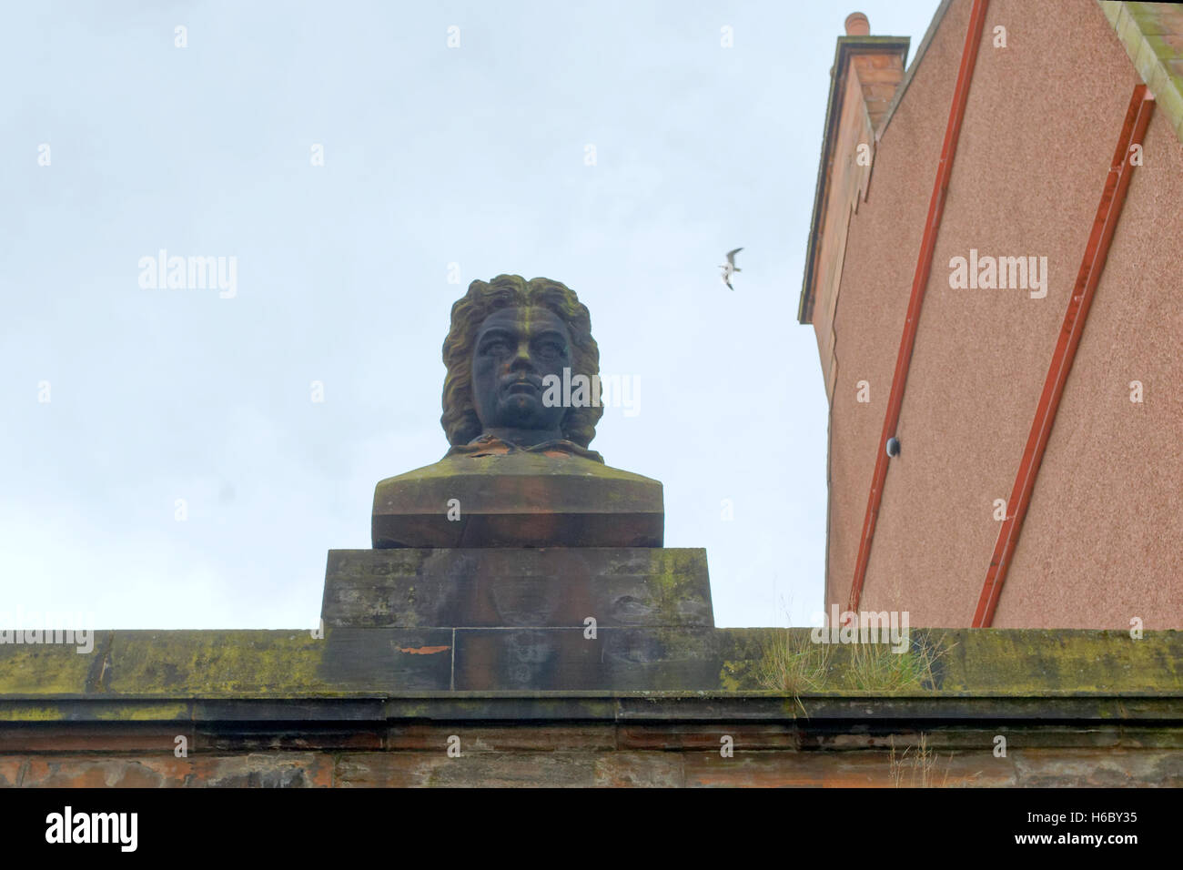 Beethoven gazes out over Renfrew Street on old building cornice of music shop once T A Ewing's Piano and Harmonium Emporium. Stock Photo