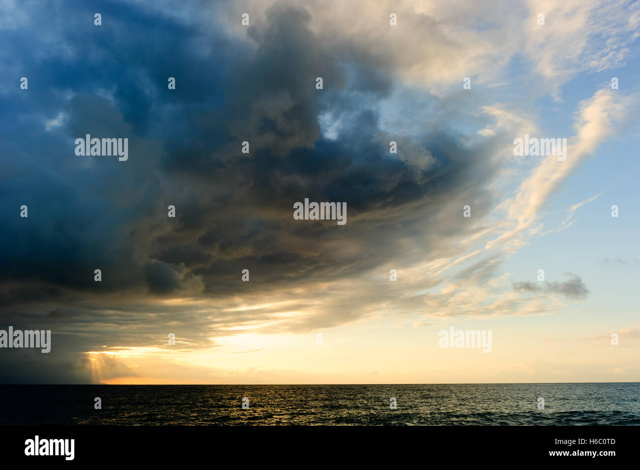 Sunset ocean storm clouds is a powerful cloudscape with sun rays ...