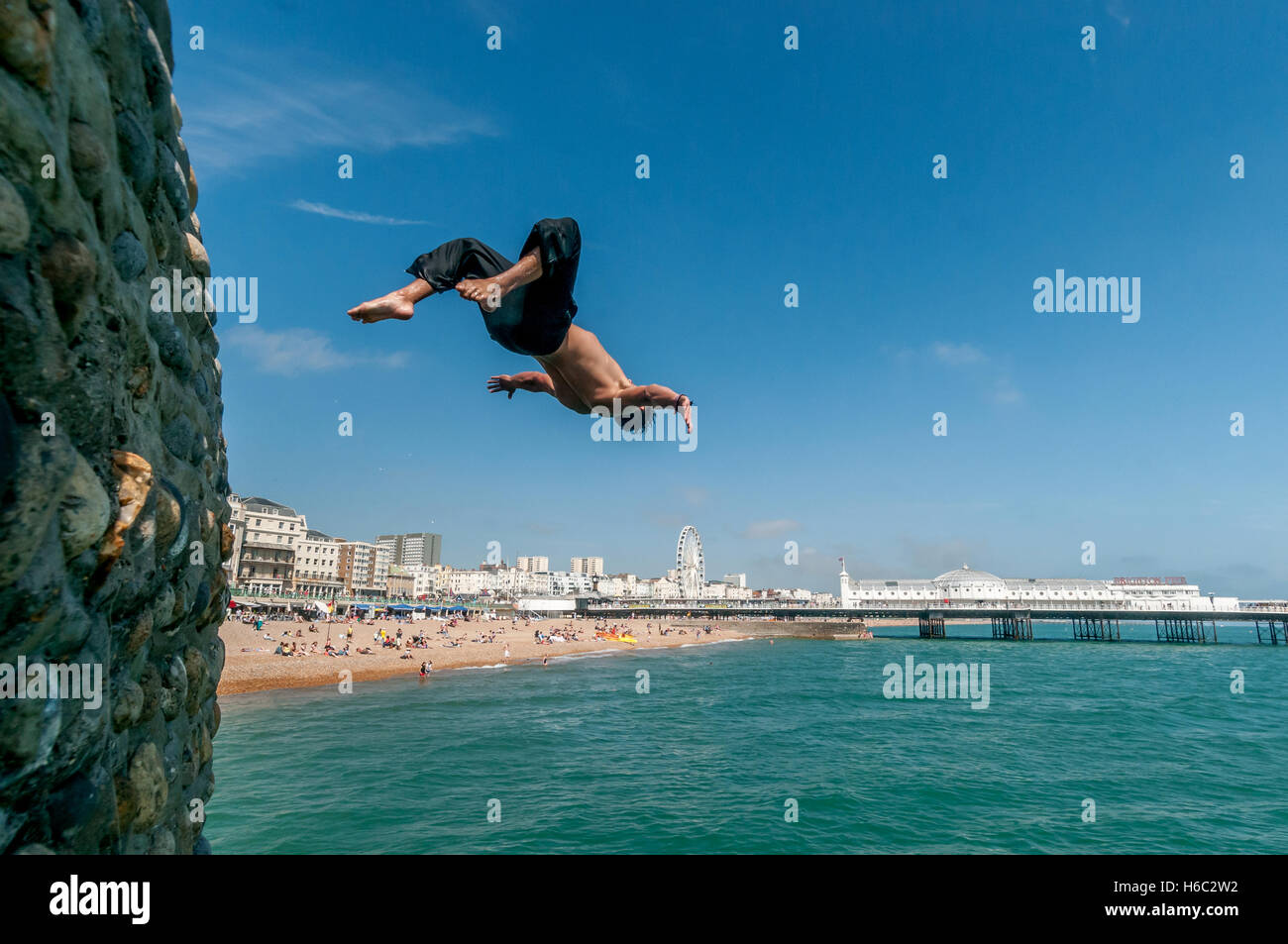 Boy diving into the sea on Brighton beach Stock Photo